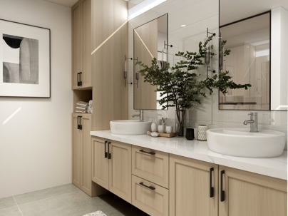 Neutral colored bathroom cabinets. Green plant between sinks.