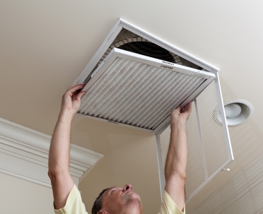 man changing HVAC air filter