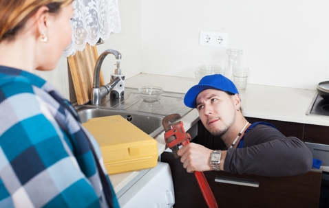 Plumber investigating noisy pipes
