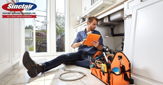 Man sits down and checks pipes