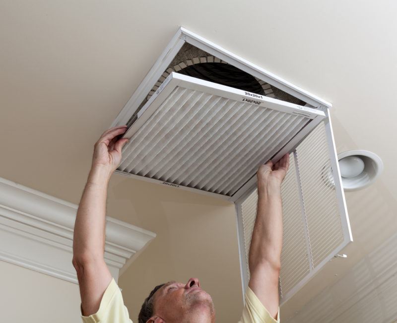 A man changing a dirty air filter