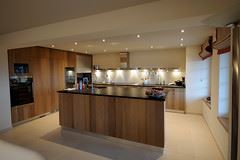 A modern kitchen with an island and wooden cabinets