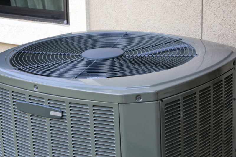 A grey outdoor HVAC unit