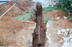 A dug trench displaying the sewer line 